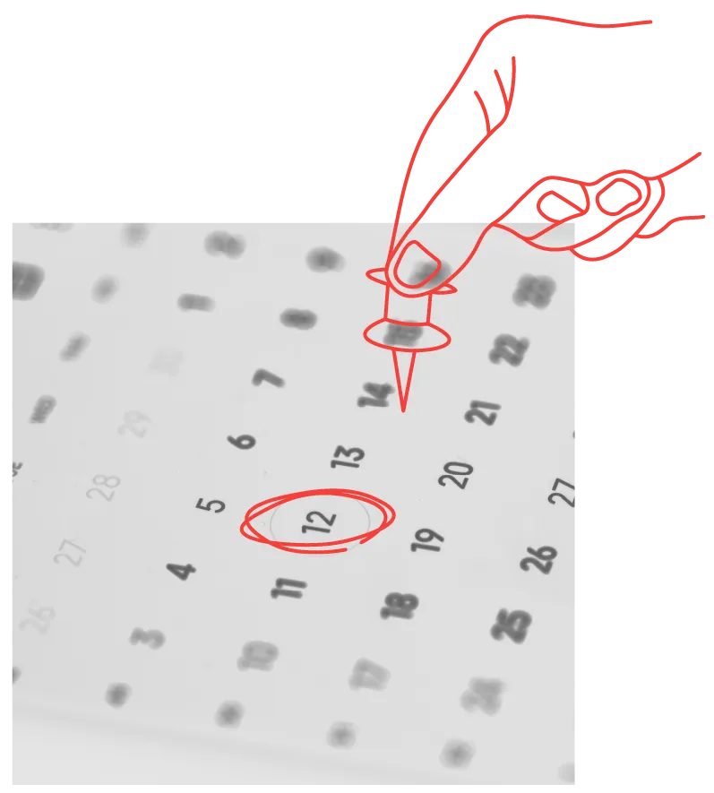 hand placing a pin on a calendar