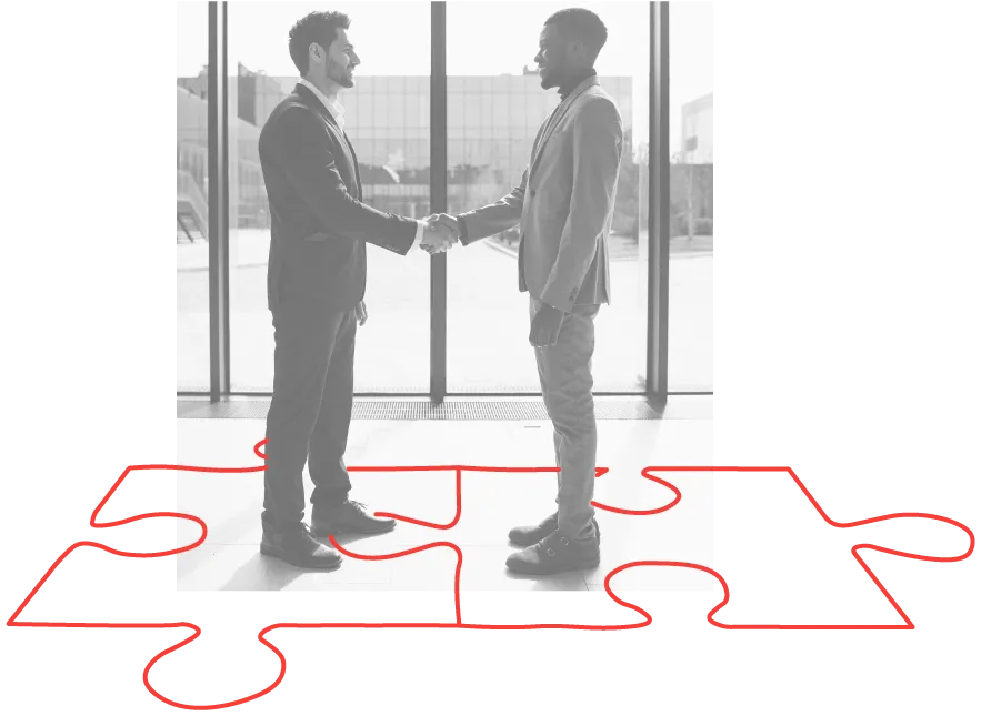 two men shaking hands standing on puzzle pieces