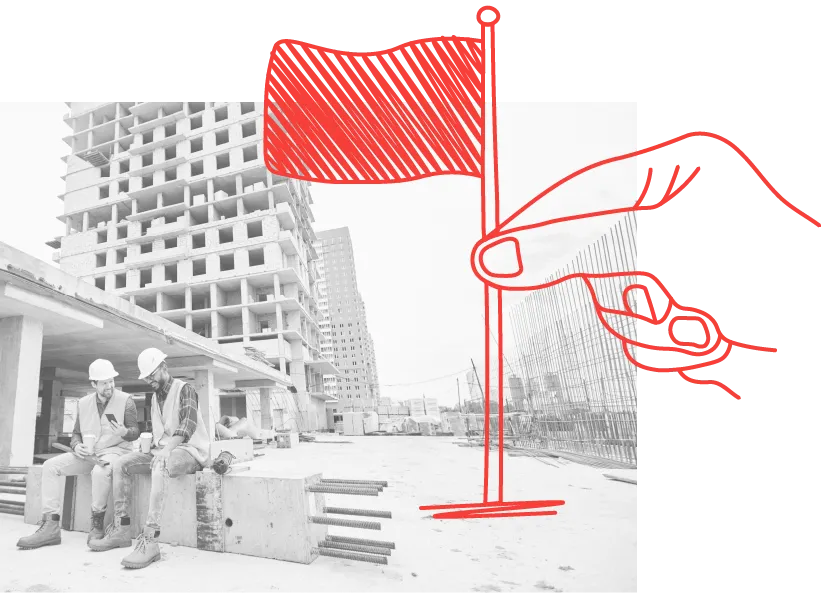 a hand planting a flag on a building site